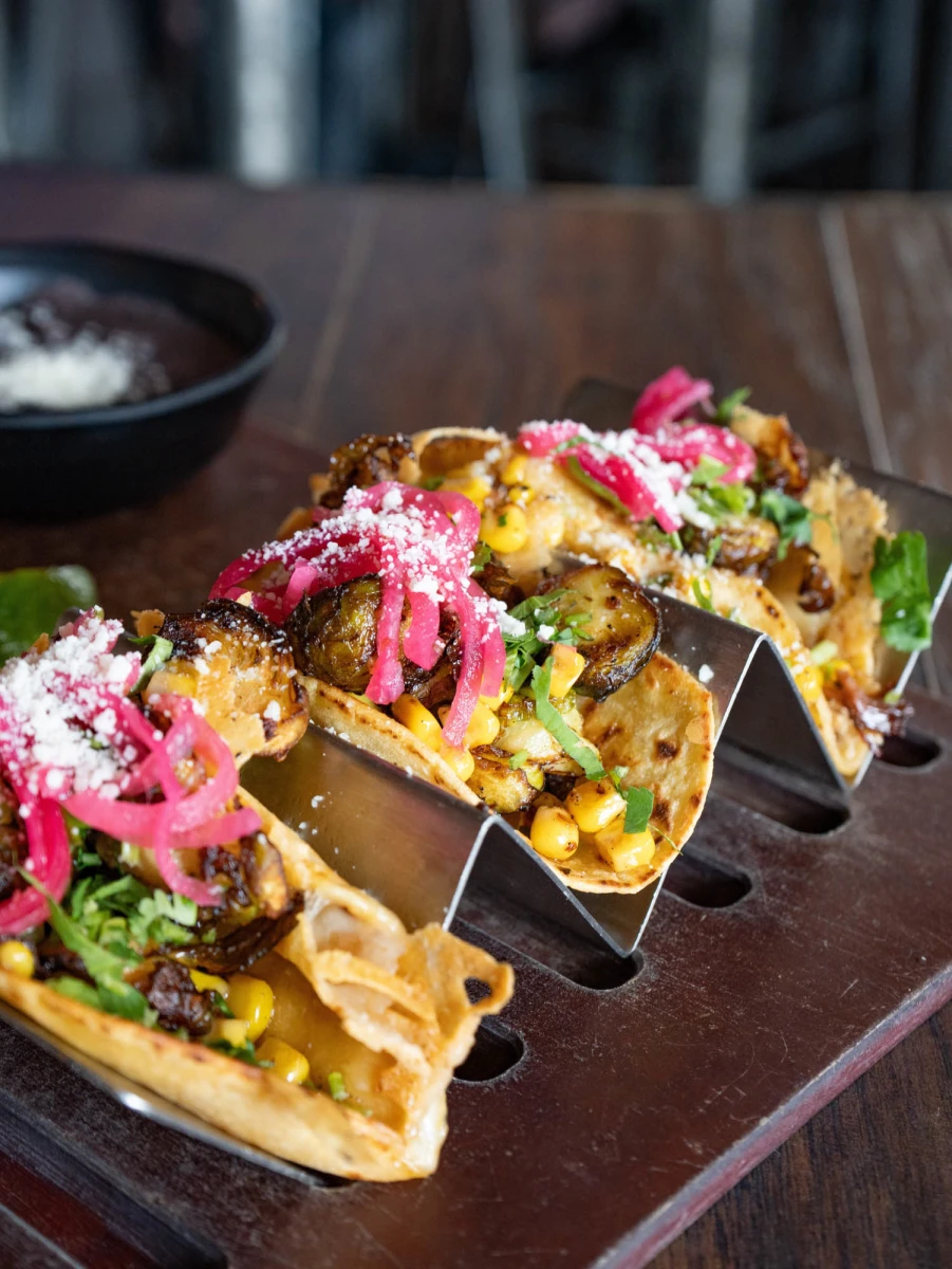 Que Onda Tacos + Tequila signature dishes Al Pastor TacosCarne Asada FriesChurros﻿﻿﻿